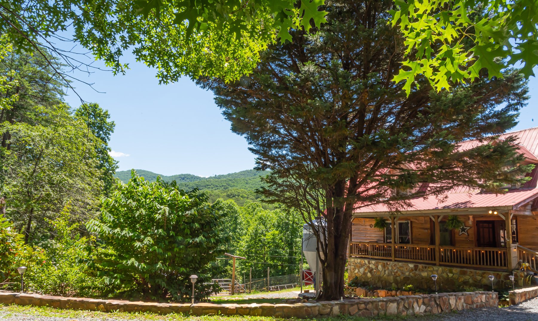 Nine Peaks Farm log home and red metal roof in Ellijay Georgia